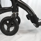 Close-up of a black wheelchair with a white background