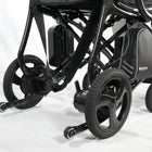 Close-up of a black electric wheelchair on a white background